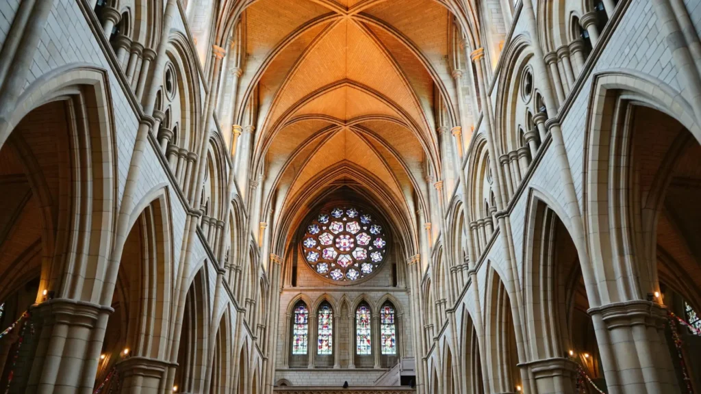 Gothic cathedral interior with stained glass windows.