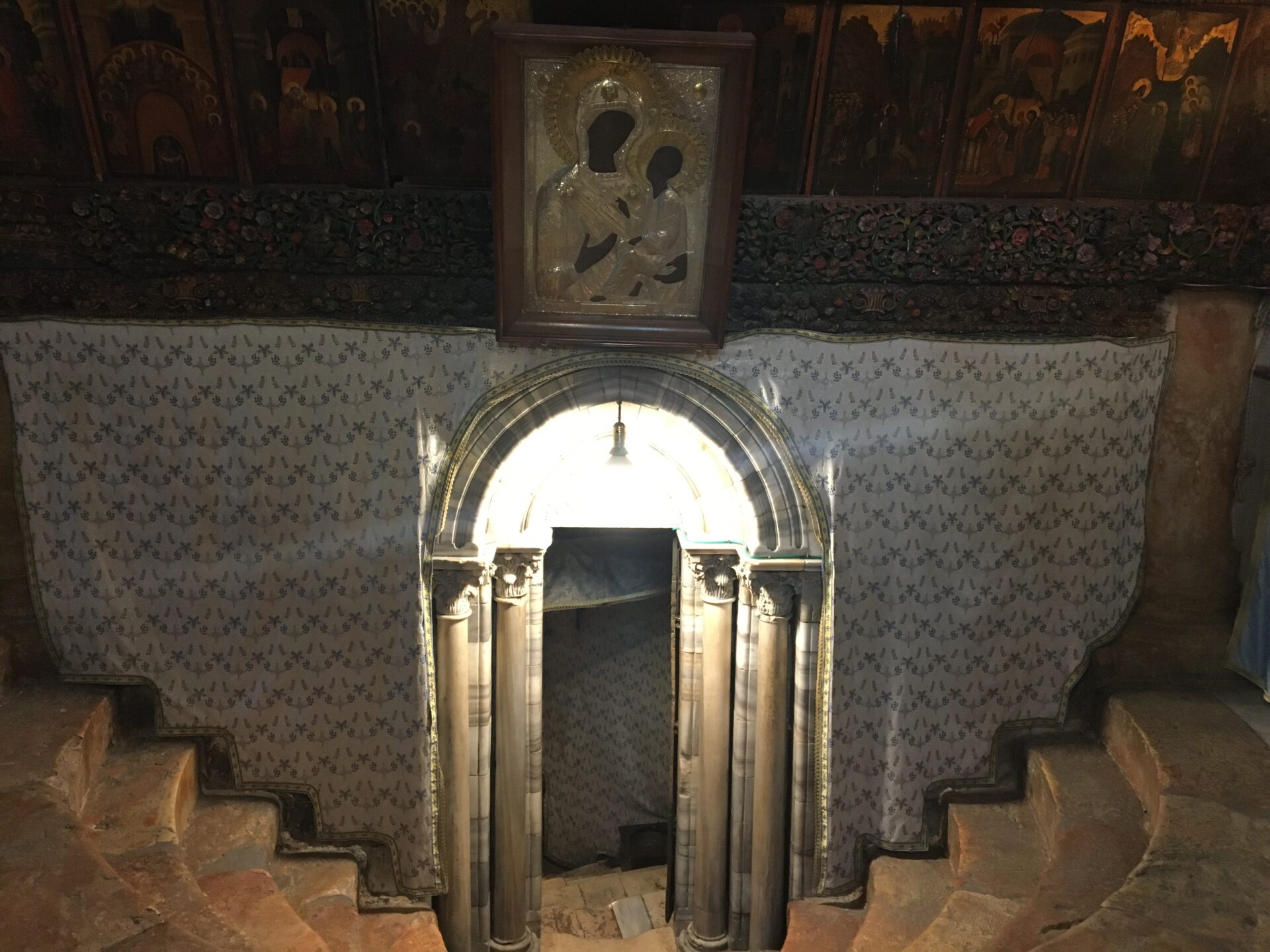 Stone archway with religious icon above.