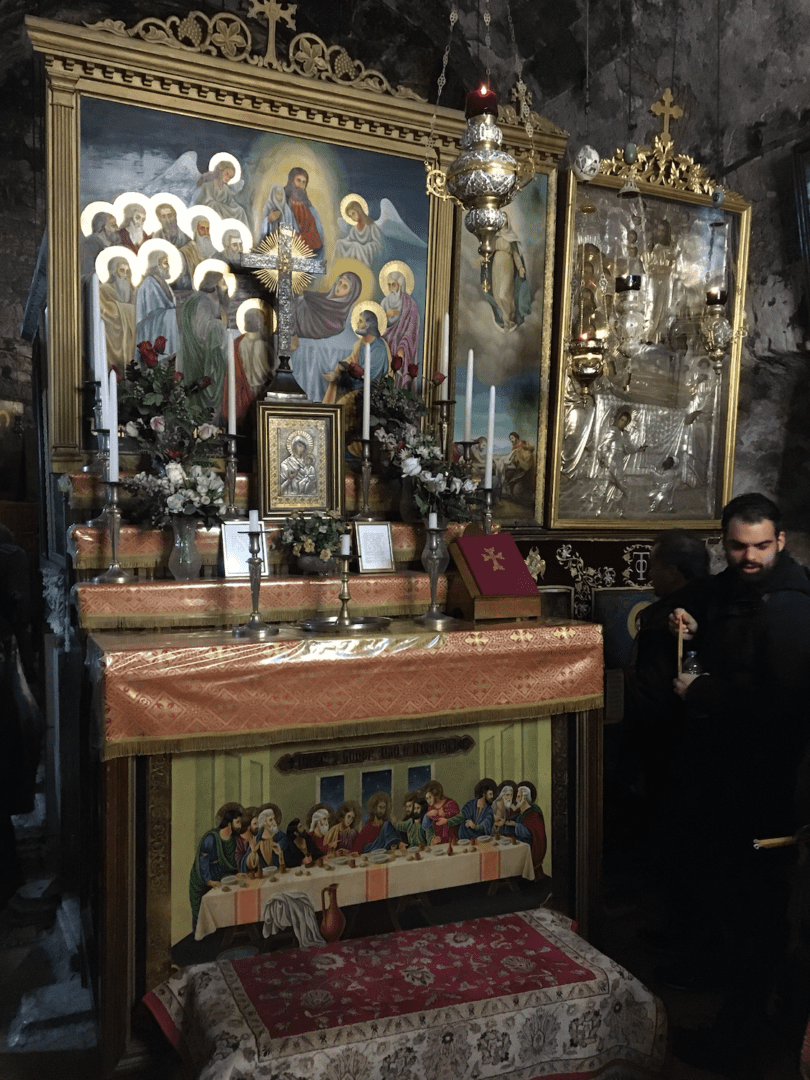 Religious altar with paintings and candles.