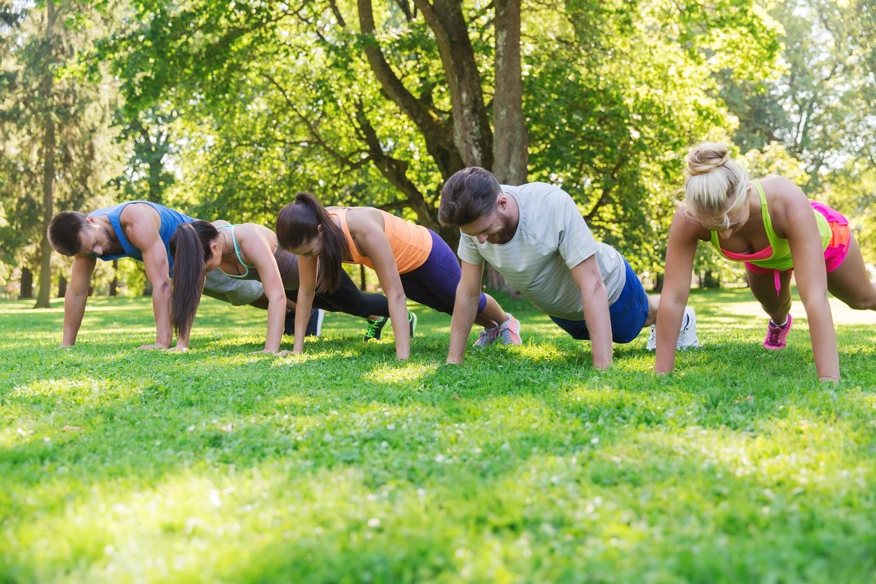 A group of people exercising at a park