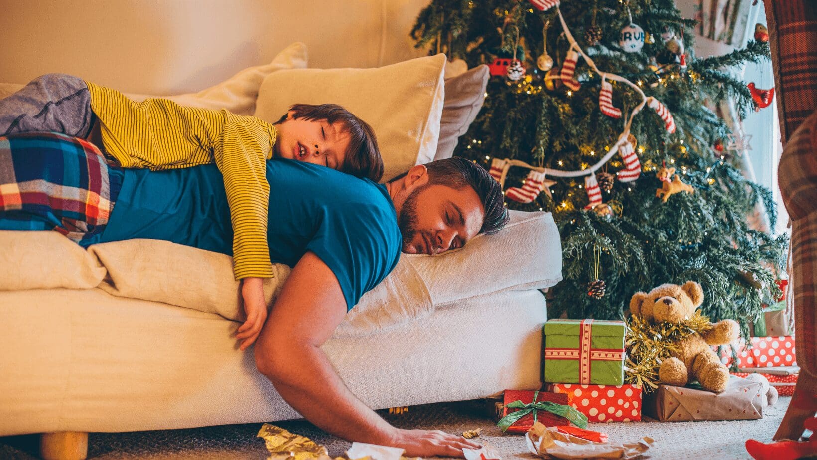 Father and son sleeping on the couch