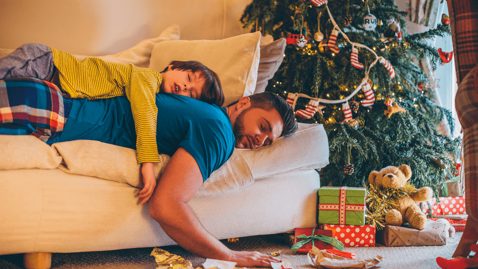 Father and son sleeping on the couch