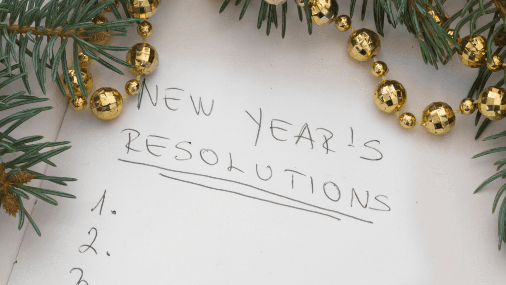 A text that says New Years Resolutions on a notebook