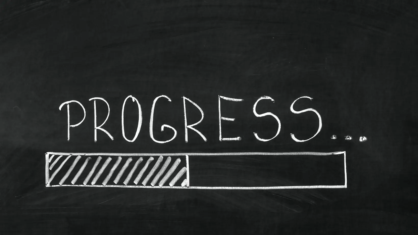 The word Progress written on the blackboard