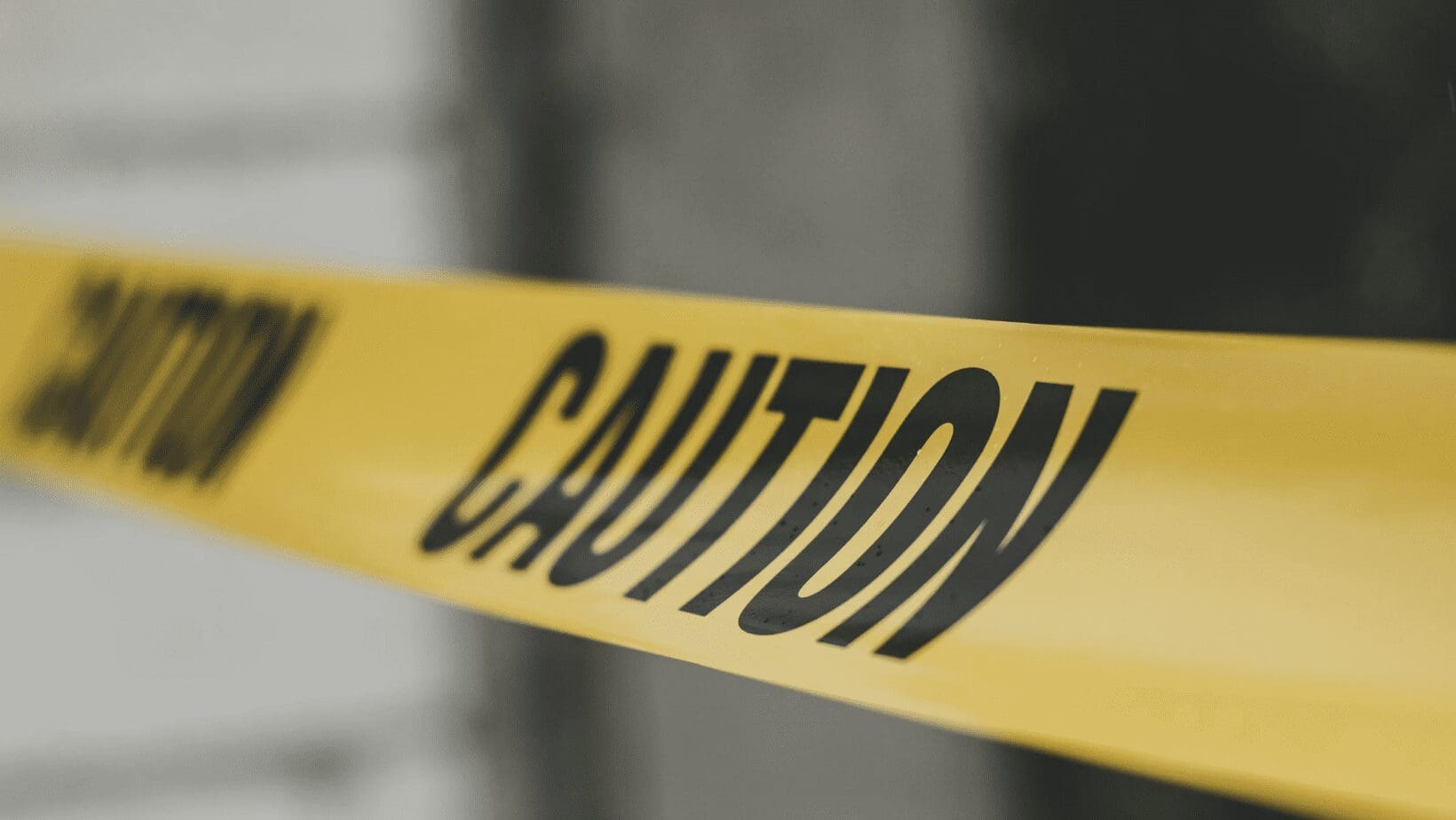 Yellow caution tape with black lettering.