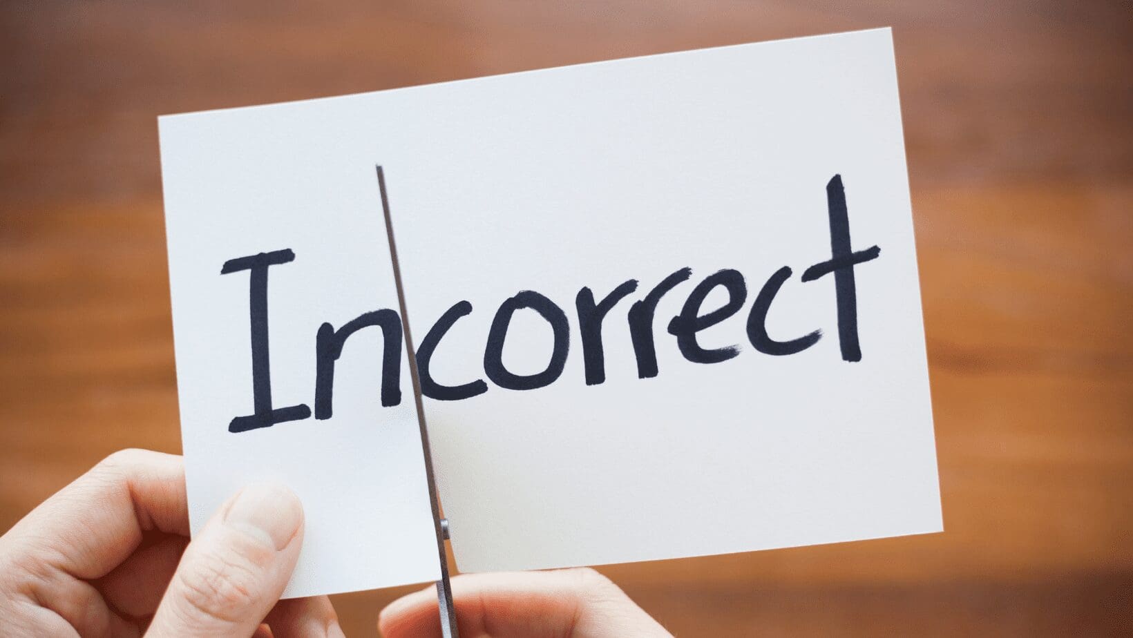 Card with "Incorrect" being cut in half.
