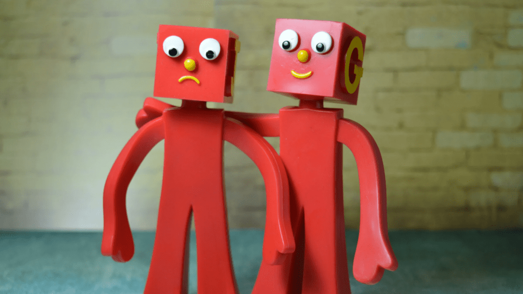 Artwork of two red toy figures