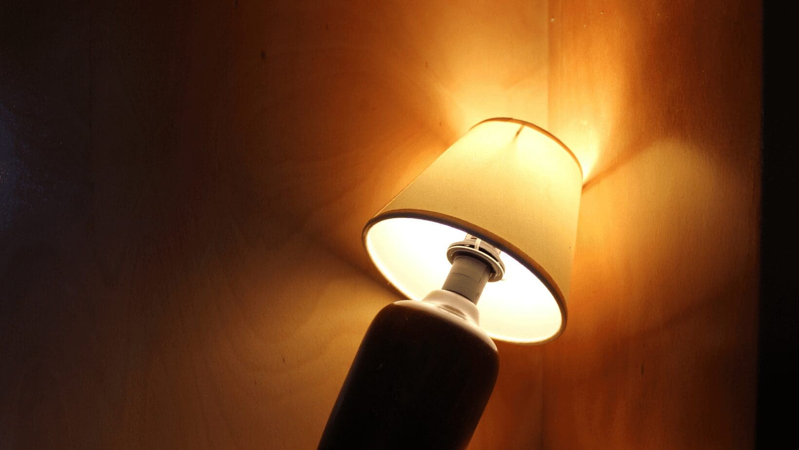 Table lamp casting soft warm light.