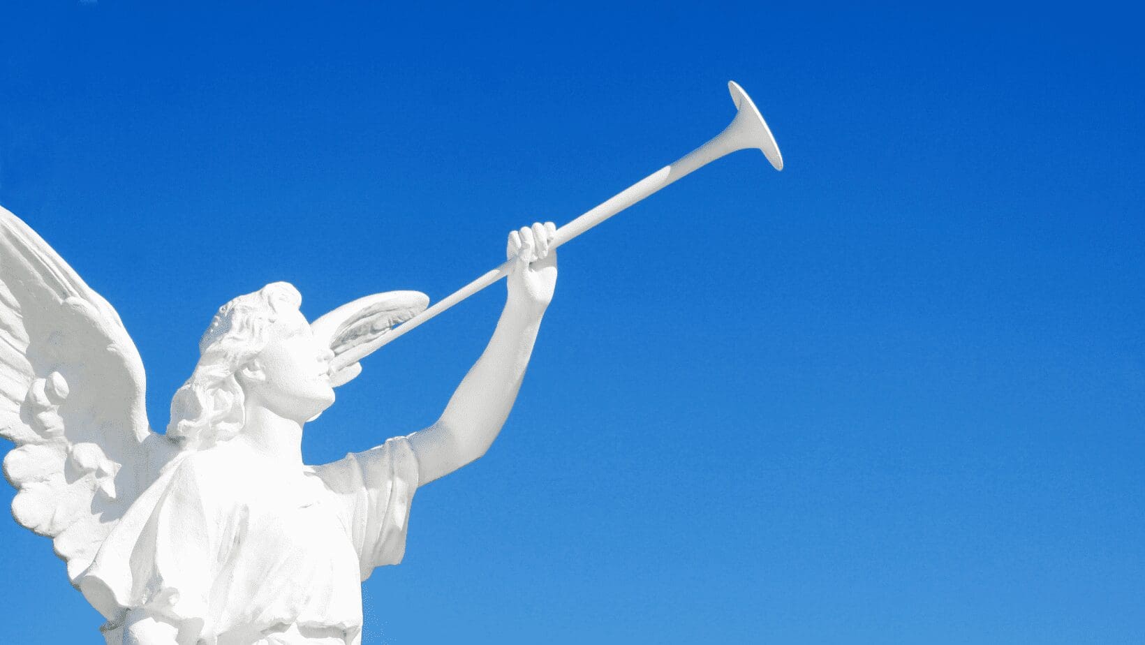 A statue of an angel blowing a trumpet