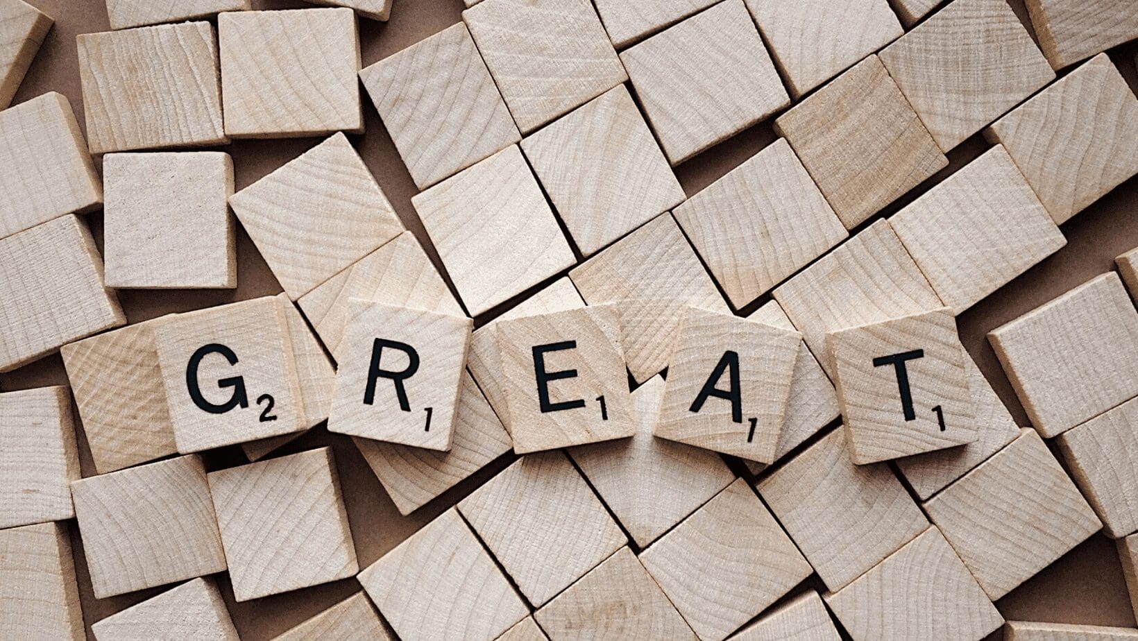 Scrabble tiles spelling the word "great".