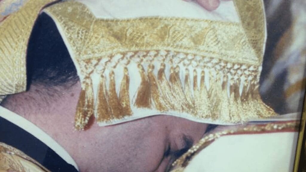 Man in ceremonial attire with gold details.