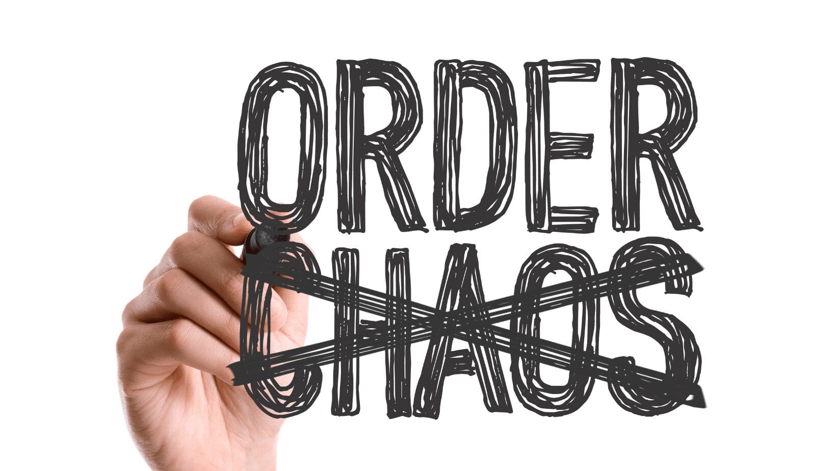 Hand crossing out "chaos," writing "order.