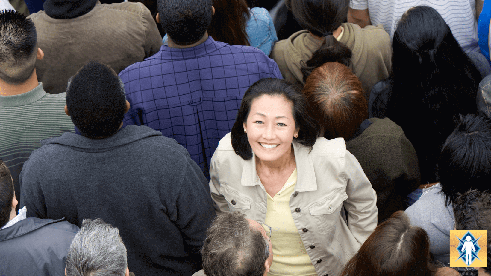 Smiling woman standing out in a crowd.