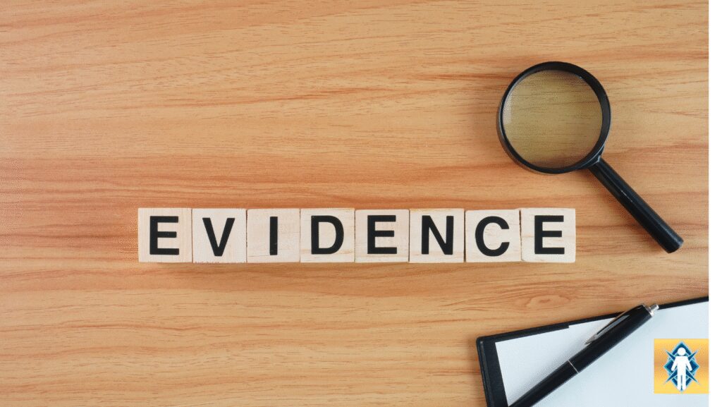 Scrabble tiles spell out the word 'EVIDENCE' with a magnifying glass and a note nearby.