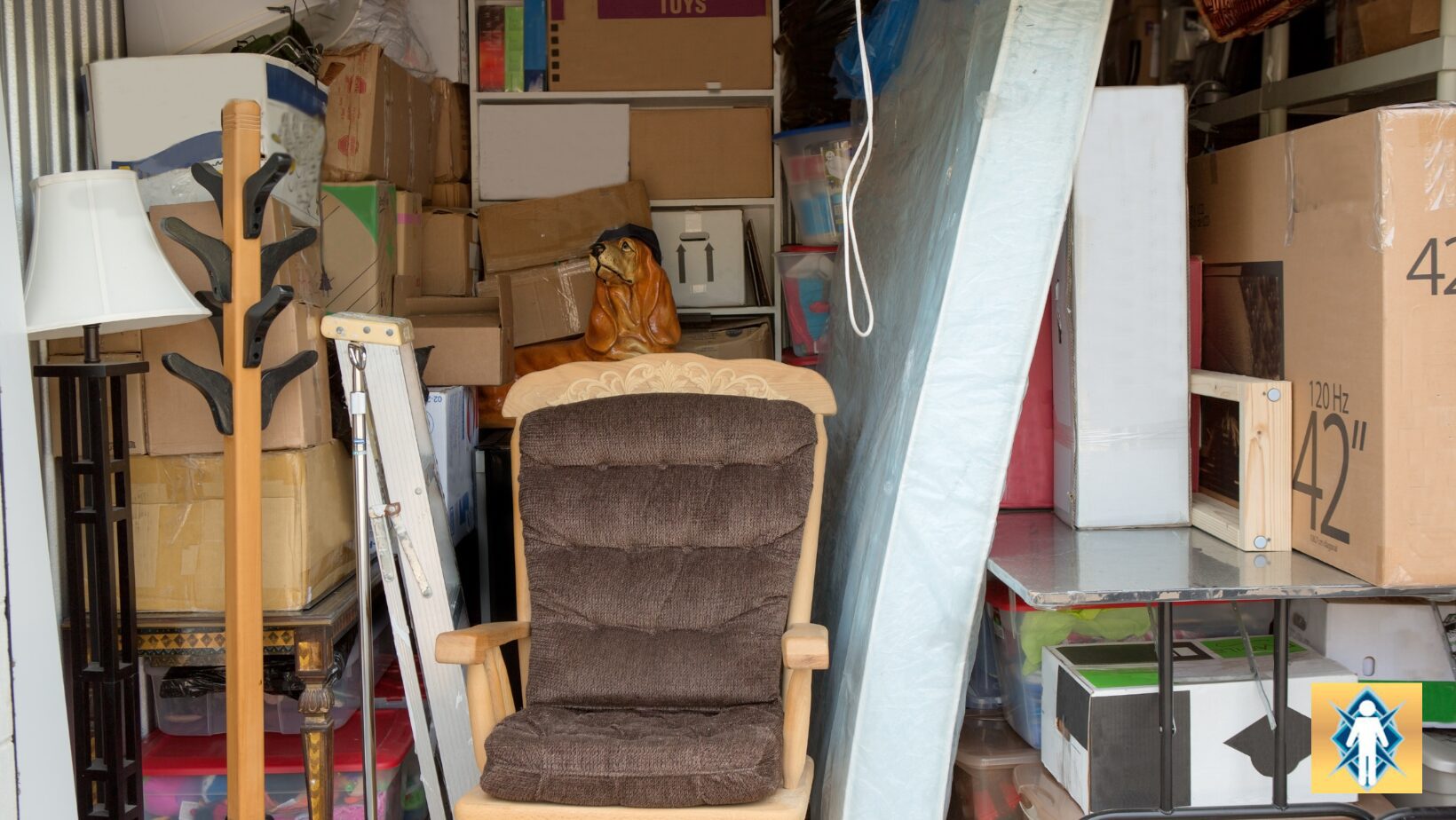 A vintage cushioned rocking chair in a cluttered storage space.