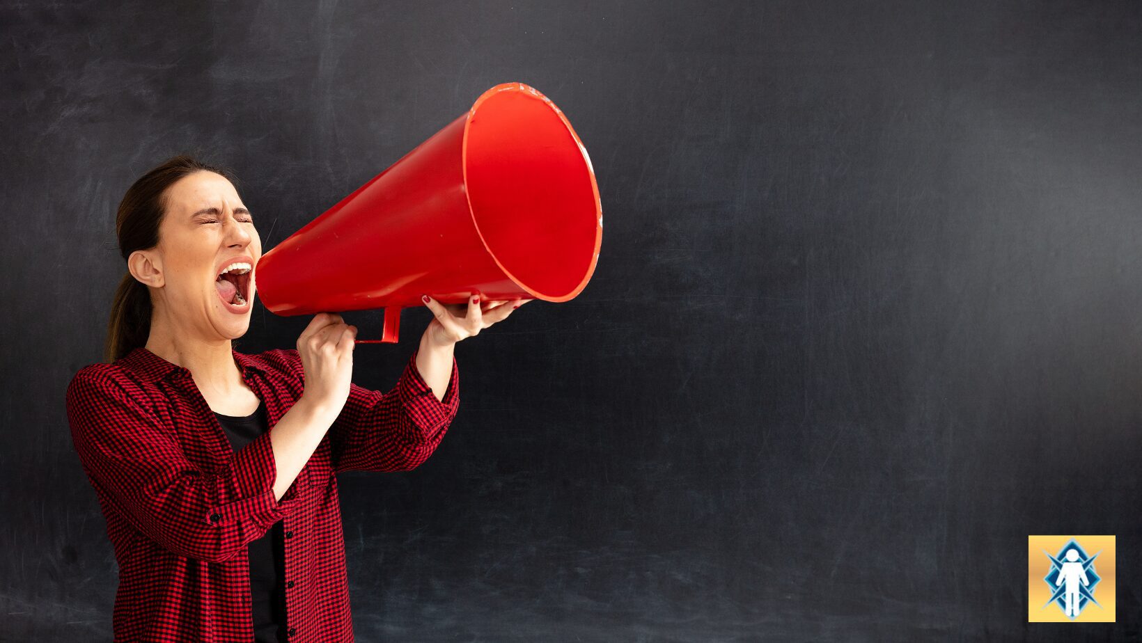 Person using a large red megaphone against a black background.