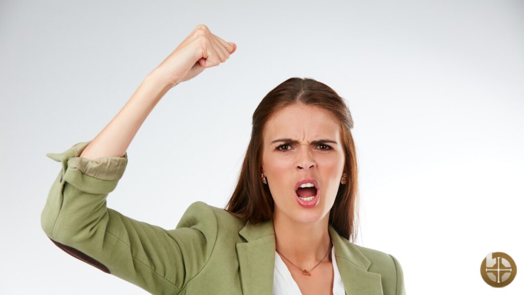 Angry woman raising her fist in protest.