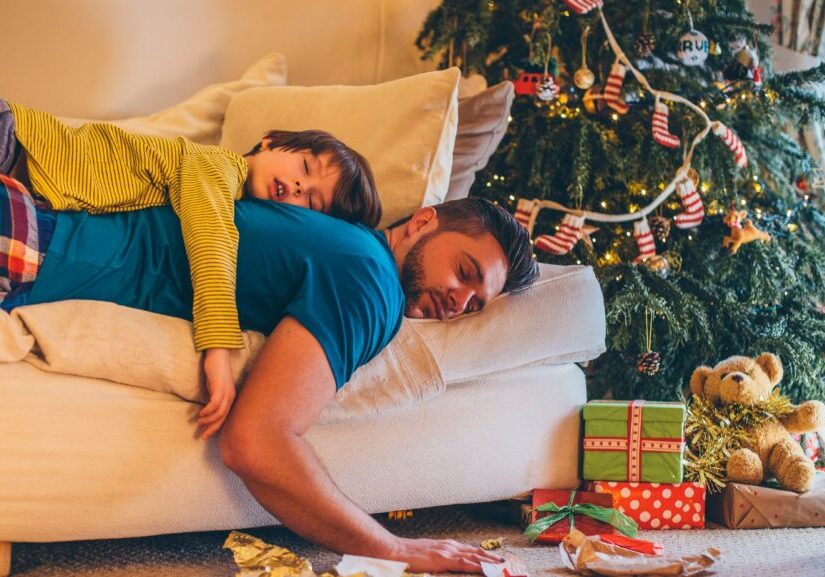 Father and son sleeping on the couch