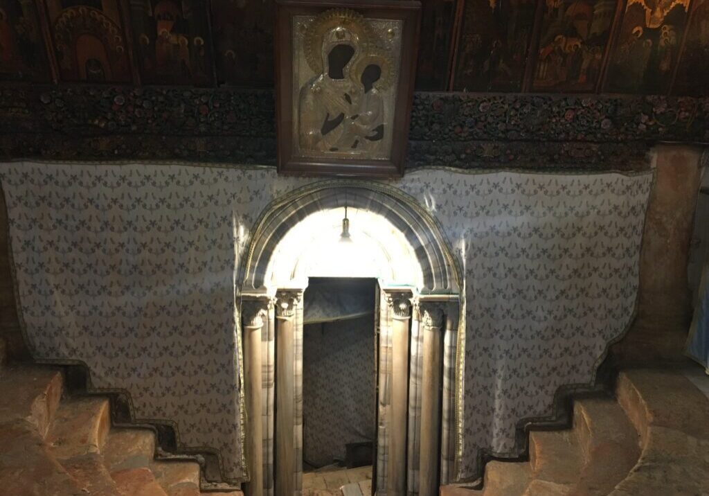 Stone archway with religious icon above.