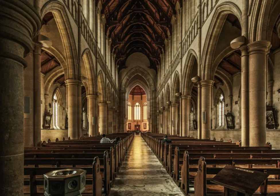 Interior of a grand, historic church aisle.