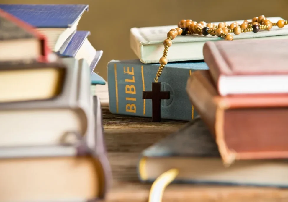 The Bible with praying beads on a table