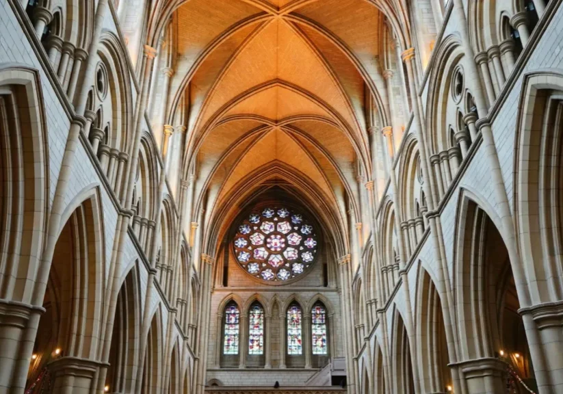 Gothic cathedral interior with stained glass windows.