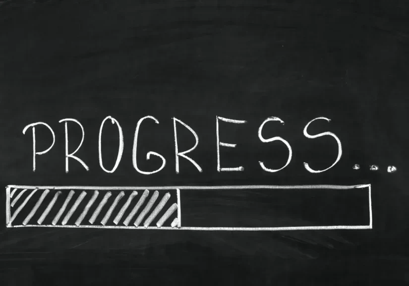 The word Progress written on the blackboard