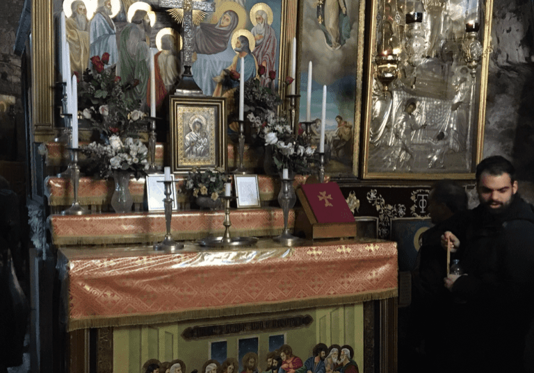 Religious altar with paintings and candles.