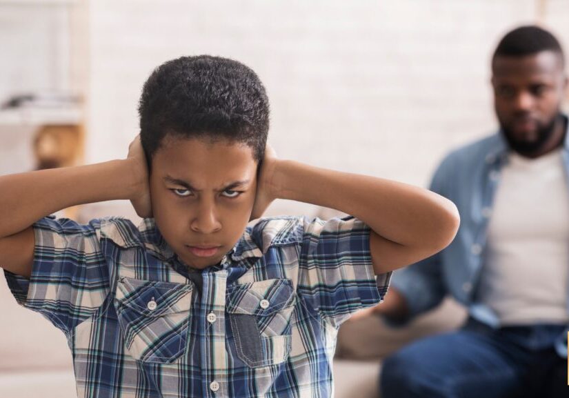Man looking frustrated and holding his head with hands behind.