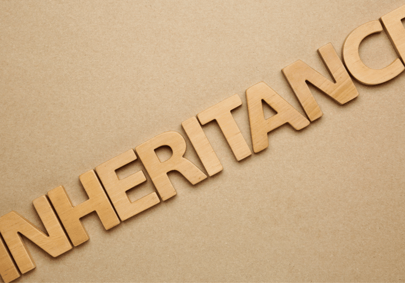 Wooden letters spelling 'Inheritance' on brown background.