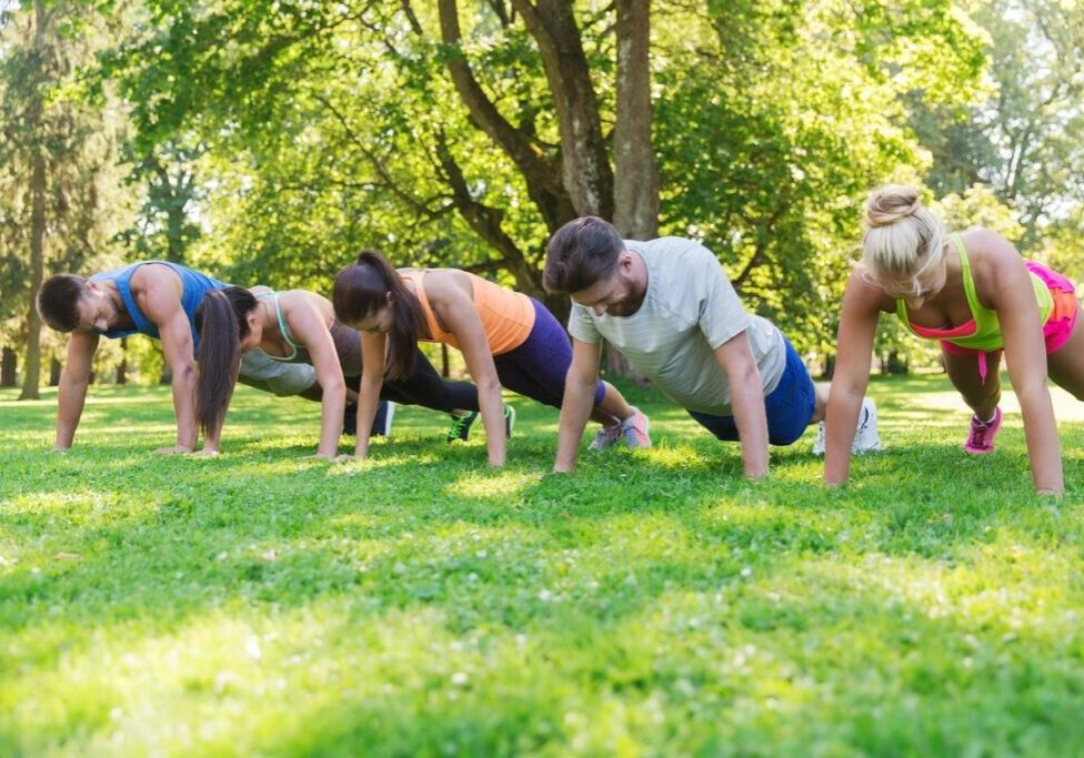 A group of people exercising at a park